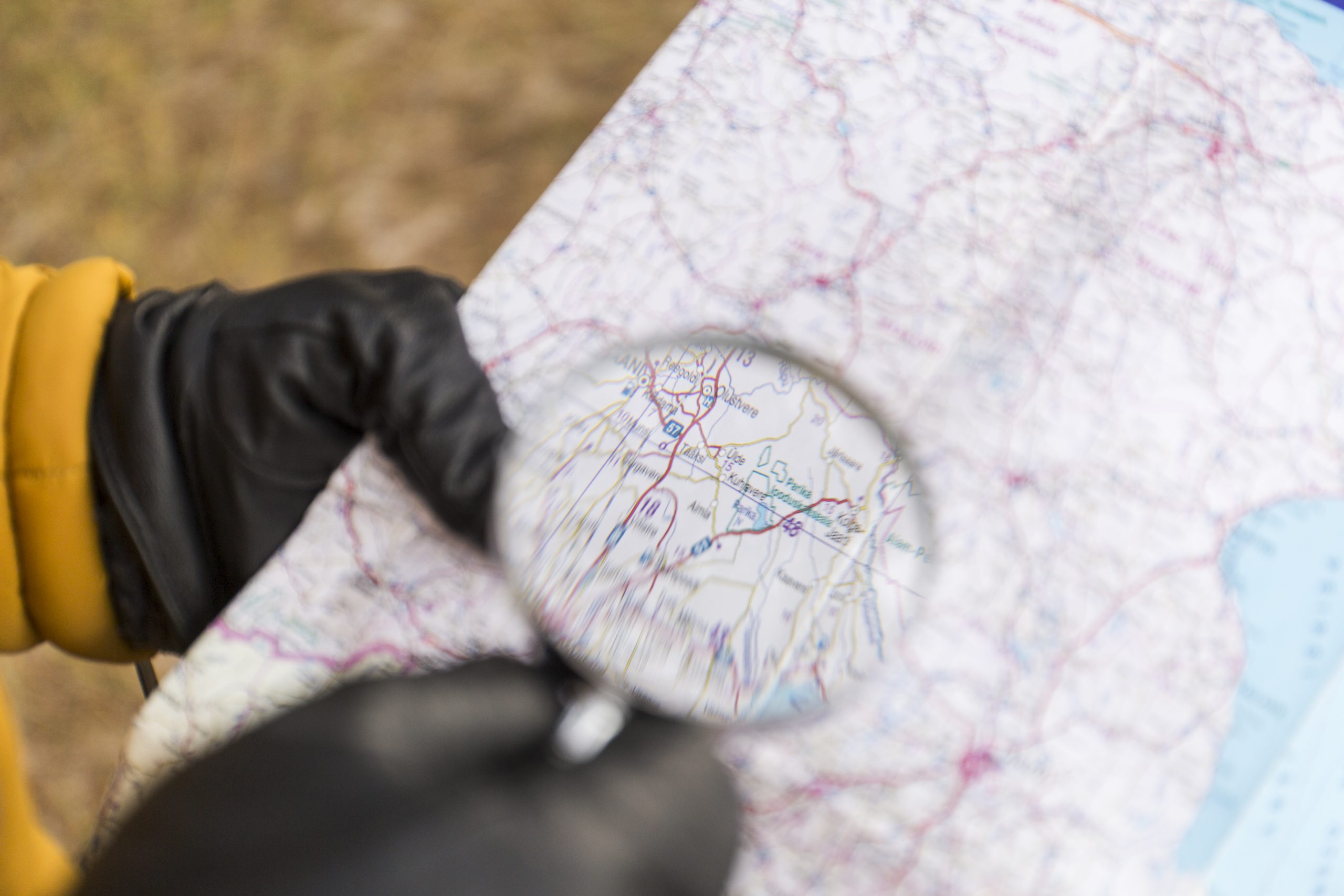 crop-hands-with-magnifying-glass-reading-map